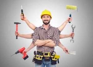 A man holds various tools in his hands, showcasing his readiness for a task or project, representing affordable handyman services near you.